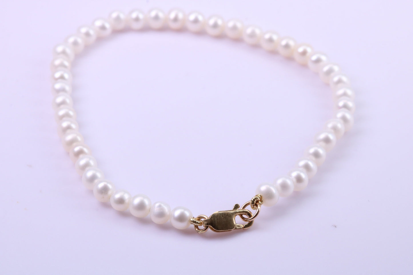 Simple 4 mm Round Natural Freshwater Pearl Bracelet set in Solid Yellow Gold