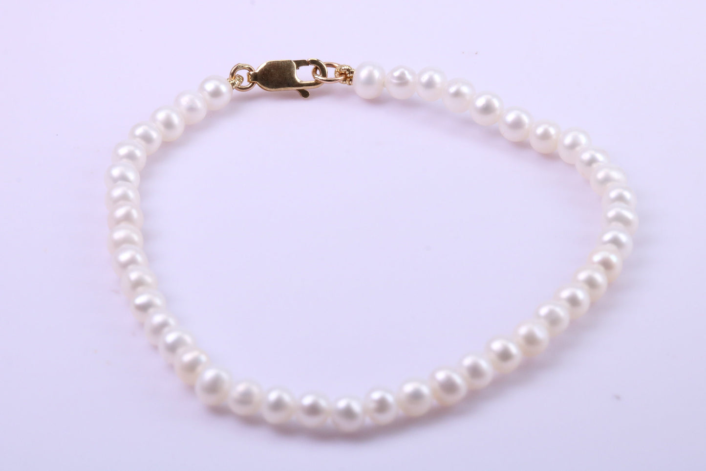 Simple 4 mm Round Natural Freshwater Pearl Bracelet set in Solid Yellow Gold