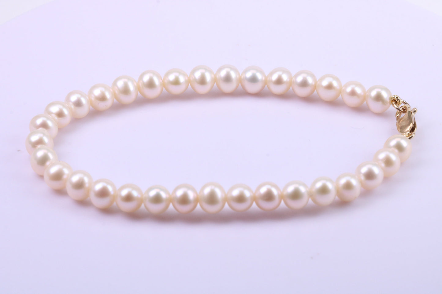 Simple 6 mm Round Natural Freshwater Pearl Bracelet set in Solid Yellow Gold