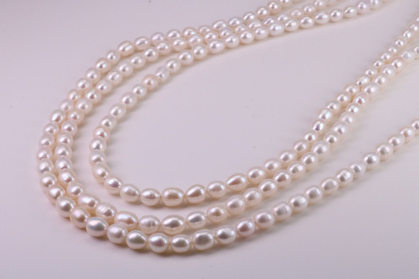 Three Strand Natural 7 mm Oval Shaped Pearl Necklace set in Silver, Three Strands Measures 16, 18 and 20 inches Long