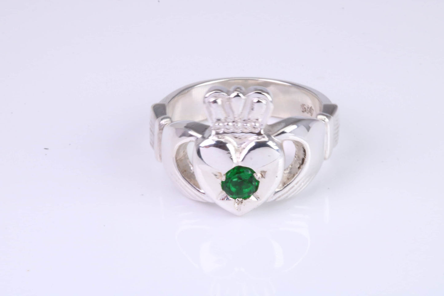 Large and heavy Emerald Green C Z set Claddagh ring, made from solid cast silver, British hallmarked