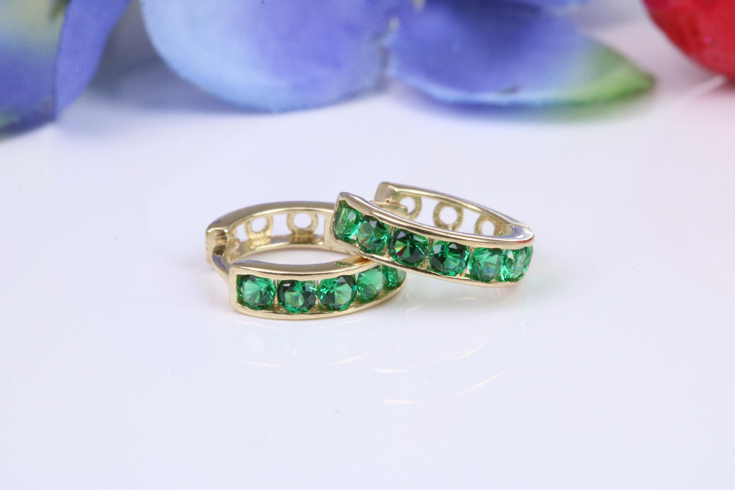 10 mm round hinged hoop earrings, made from solid yellow gold and set with Emerald Green Cubic Zirconia