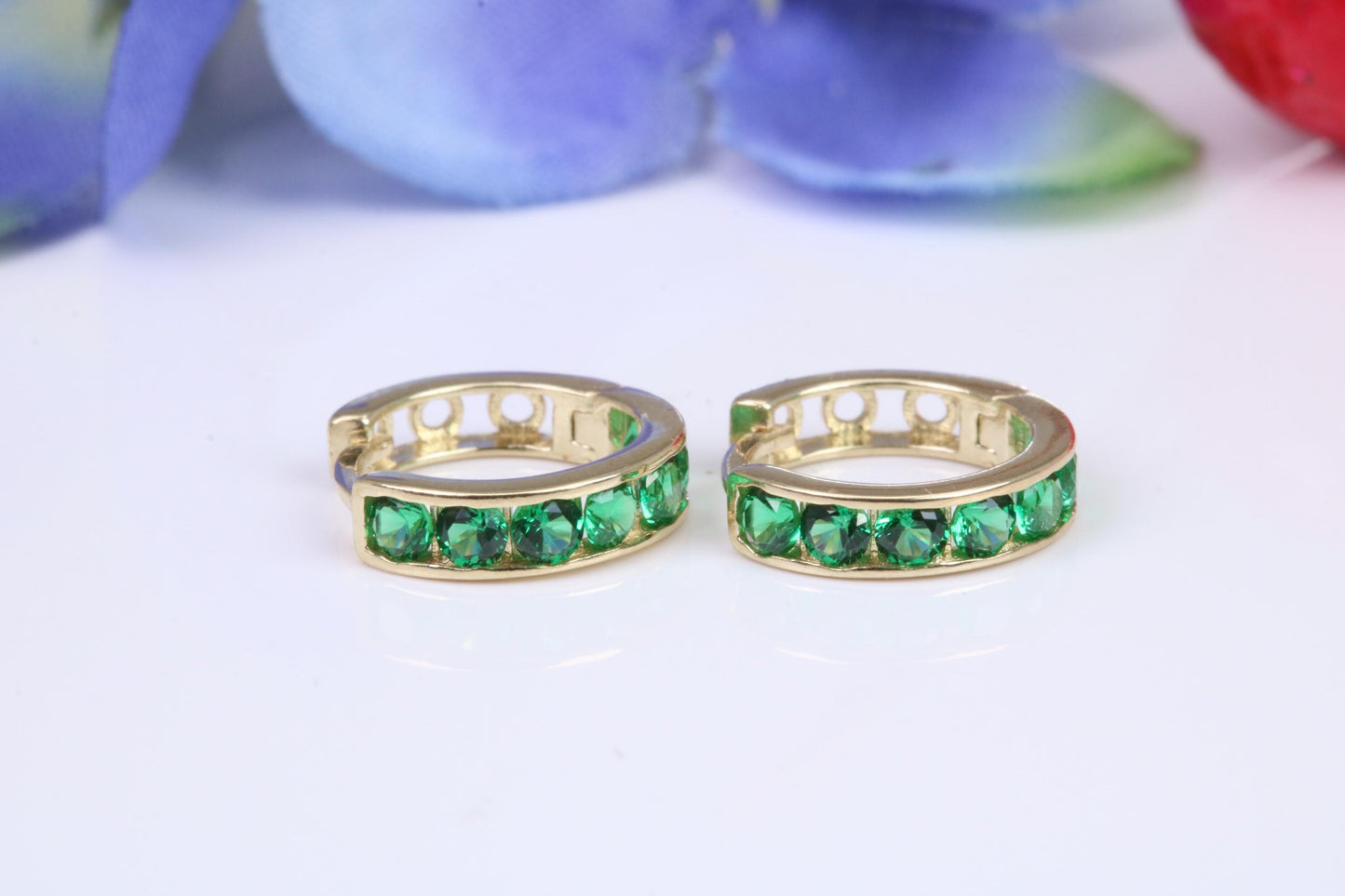 10 mm round hinged hoop earrings, made from solid yellow gold and set with Emerald Green Cubic Zirconia