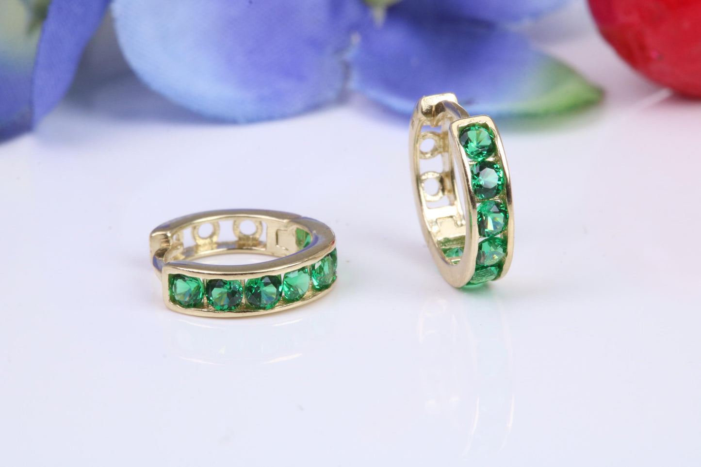 10 mm round hinged hoop earrings, made from solid yellow gold and set with Emerald Green Cubic Zirconia
