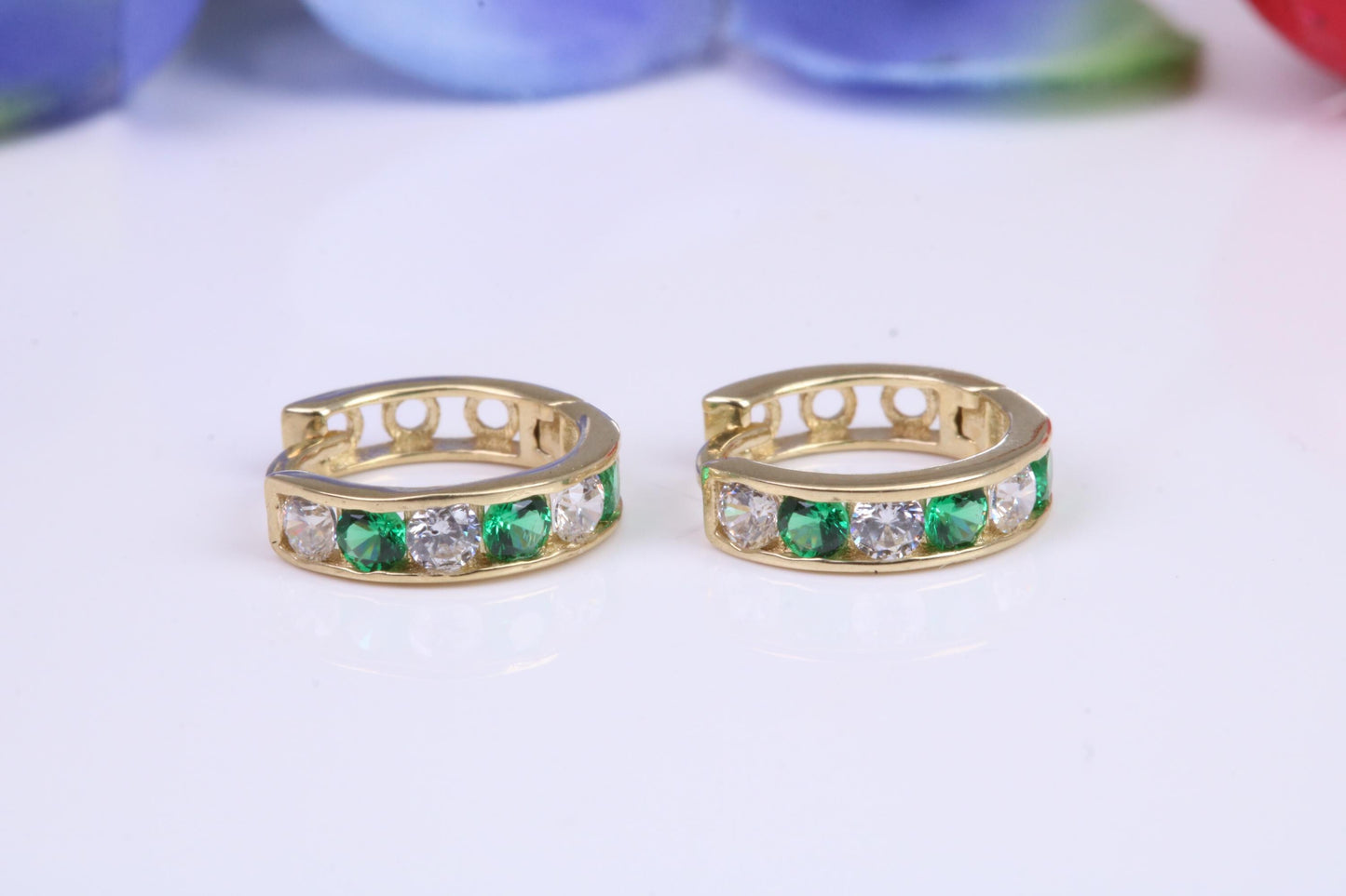 10 mm round hinged hoop earrings, made from solid yellow gold and set with Emerald and Diamond Cubic Zirconia