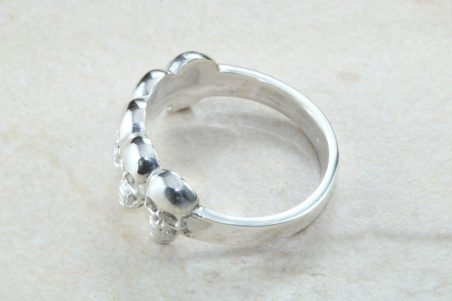 Skull ring,solid silver, 5 skulls around ring, perfect for ladies and gents. Available in Silver, Yellow gold, White gold and Platinum