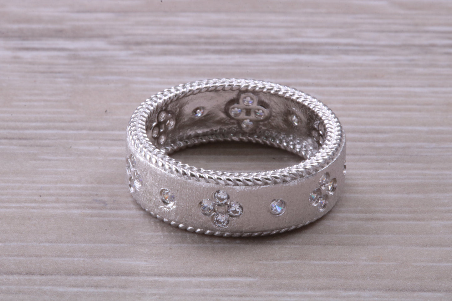 Sterling Silver Gold 7 mm wide band, Rhodium plated and set with Diamond White C Z
