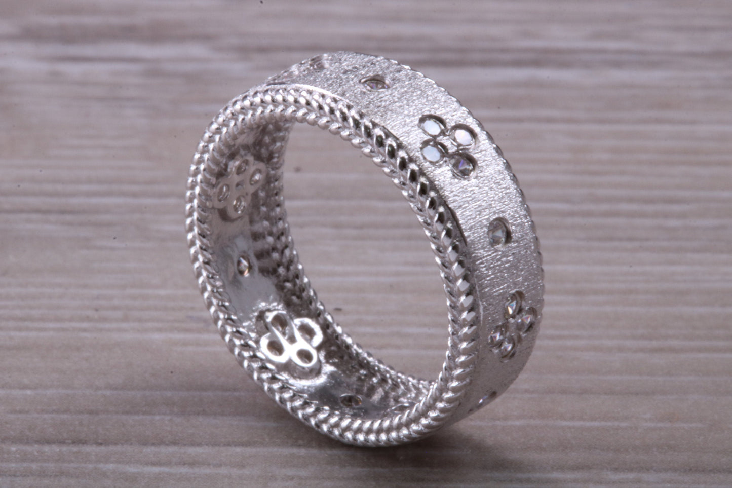 Sterling Silver Gold 7 mm wide band, Rhodium plated and set with Diamond White C Z