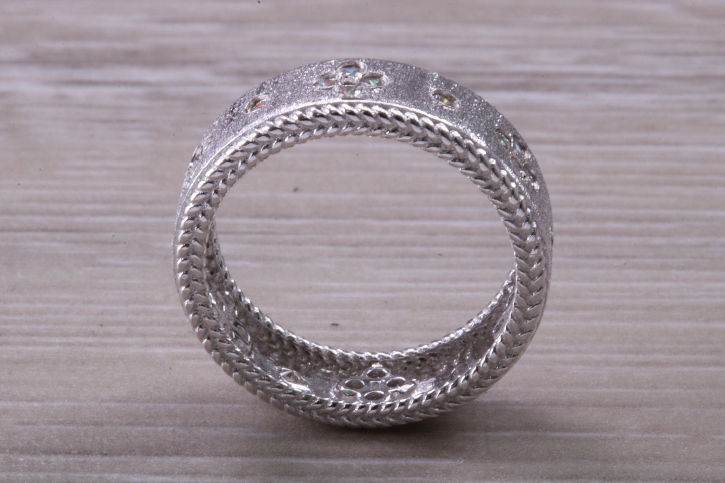 Sterling Silver Gold 7 mm wide band, Rhodium plated and set with Diamond White C Z