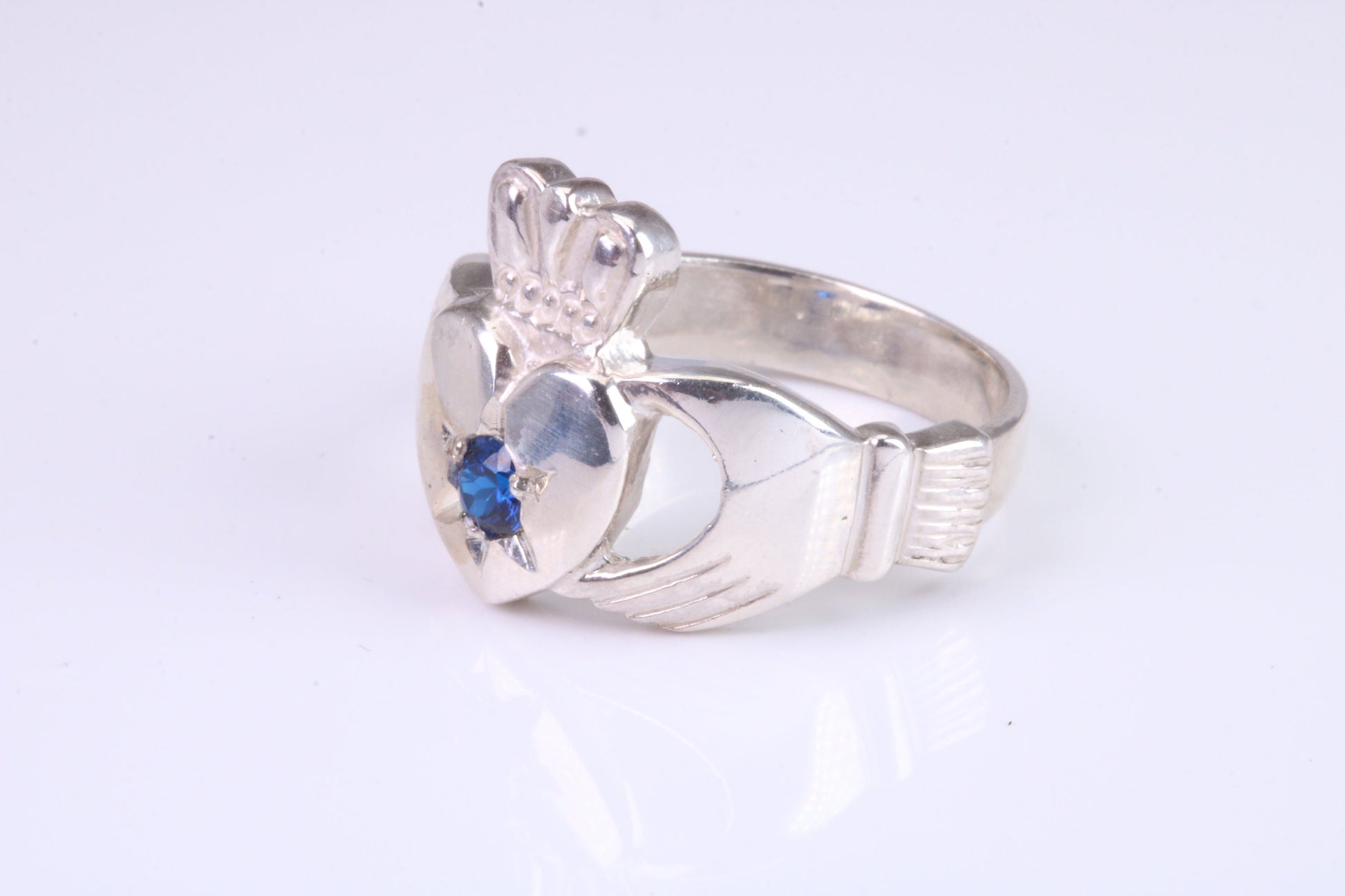 Large and heavy stone set Claddagh ring, set with Sapphire Blue C Z, solid cast silver
