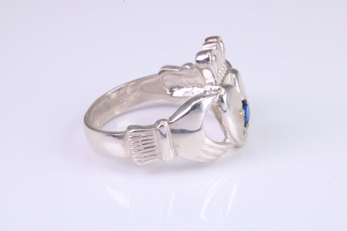 Large and heavy stone set Claddagh ring, set with Sapphire Blue C Z, solid cast silver