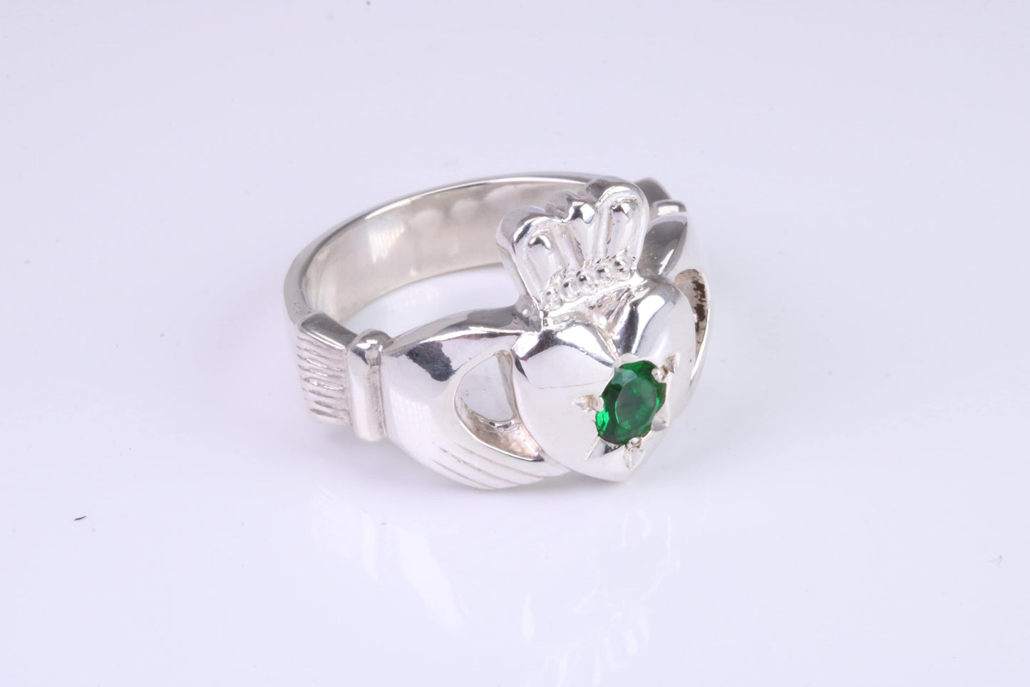 Large and heavy Emerald Green C Z set Claddagh ring, made from solid cast silver, British hallmarked