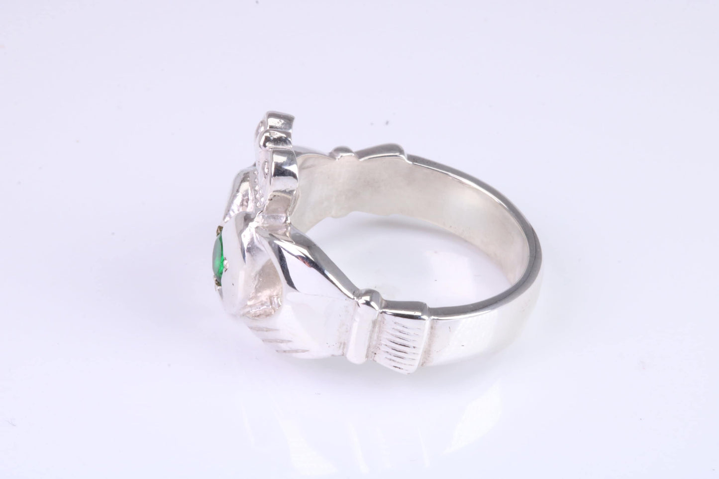 Large and heavy Emerald Green C Z set Claddagh ring, made from solid cast silver, British hallmarked