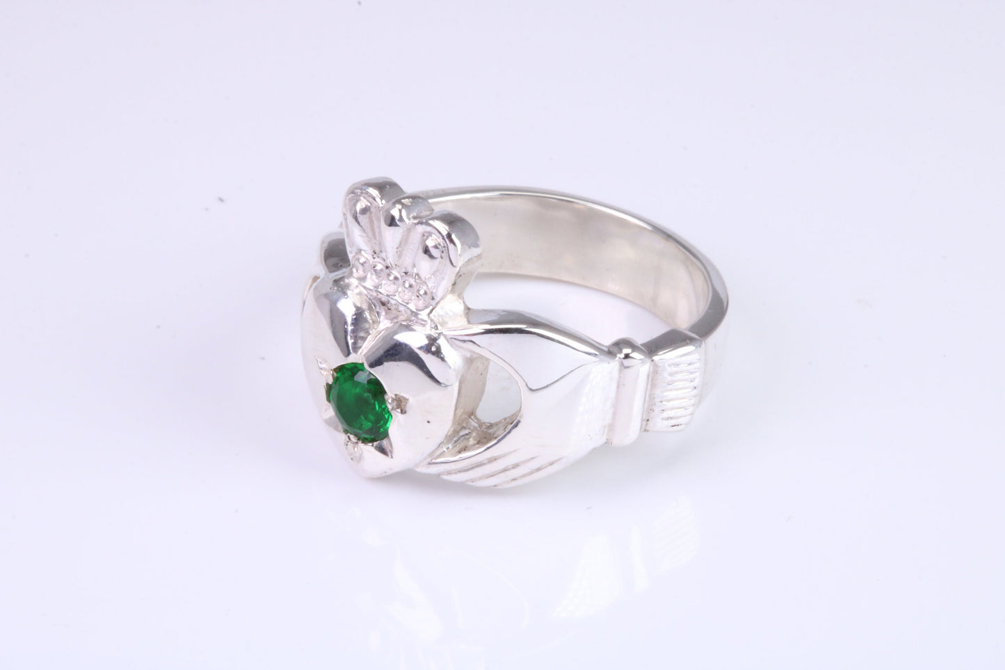 Large and heavy Emerald Green C Z set Claddagh ring, made from solid cast silver, British hallmarked