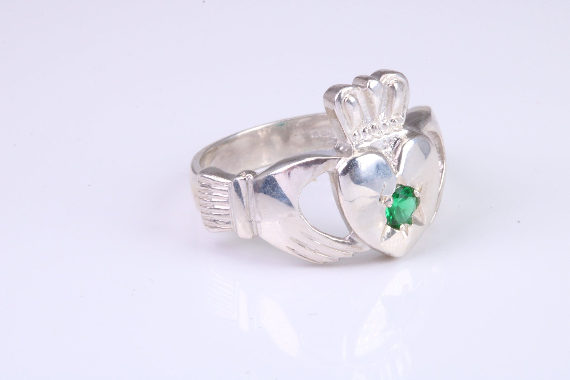 Large and heavy stone set Claddagh ring, set with Emerald Green C Z, solid cast silver