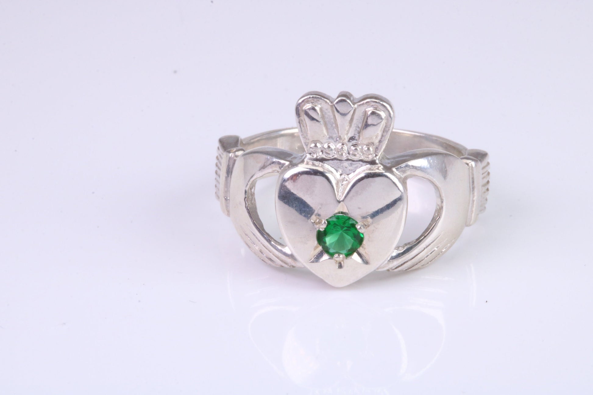 Large and heavy stone set Claddagh ring, set with Emerald Green C Z, solid cast silver