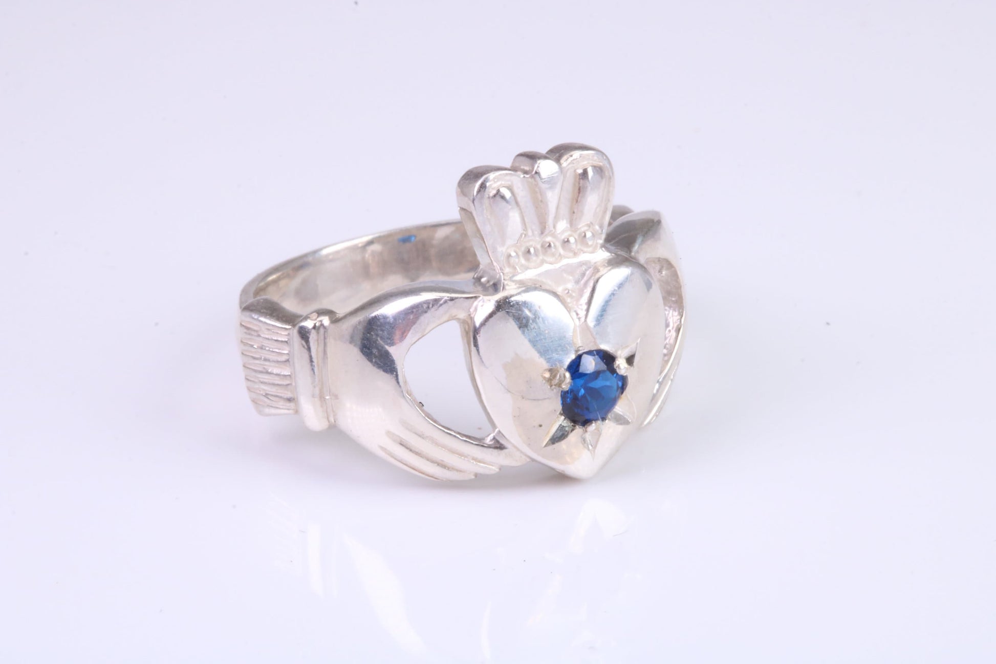 Large and heavy stone set Claddagh ring, set with Sapphire Blue C Z, solid cast silver
