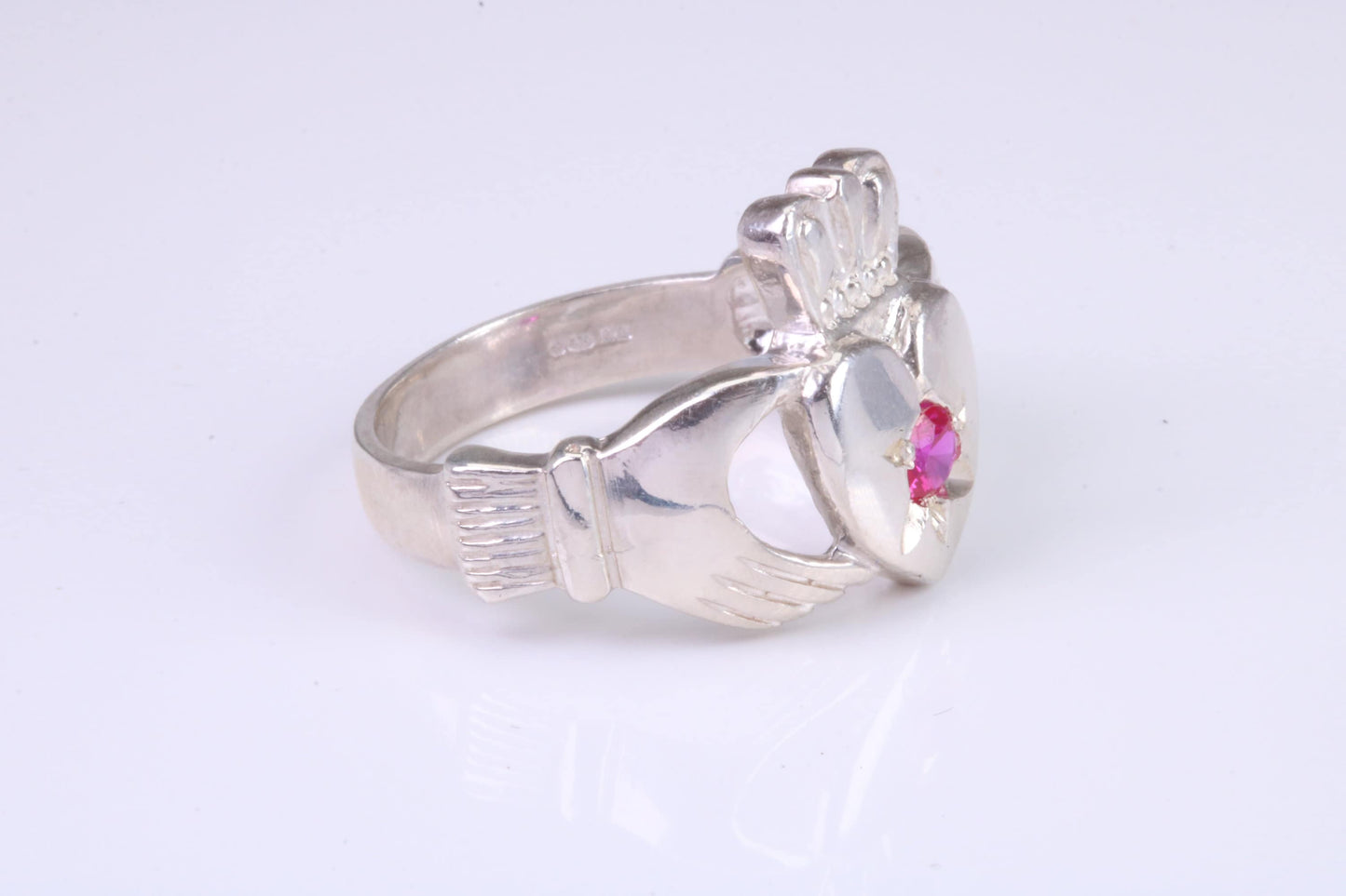 Large and heavy stone set Claddagh ring, set with Ruby Red C Z, solid cast silver