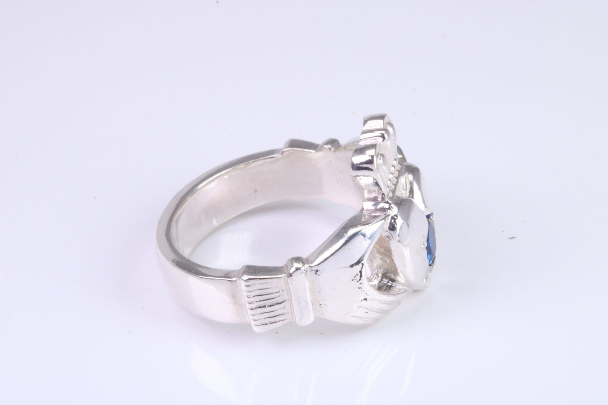 Large and heavy Sapphire Blue C Z set Claddagh ring, made from solid cast silver, British hallmarked