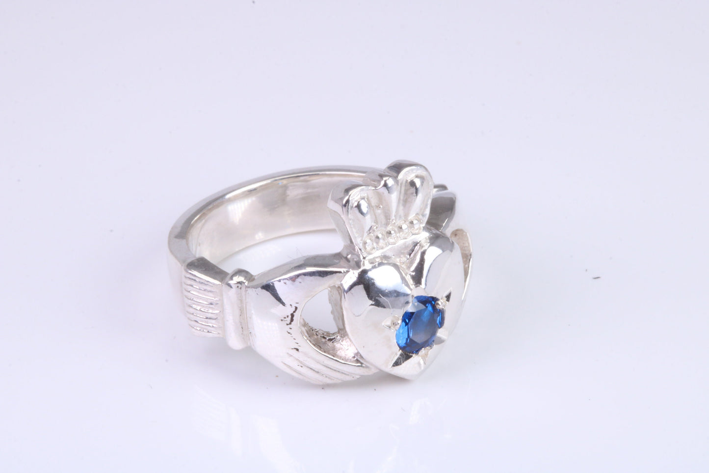 Large and heavy Sapphire Blue C Z set Claddagh ring, made from solid cast silver, British hallmarked