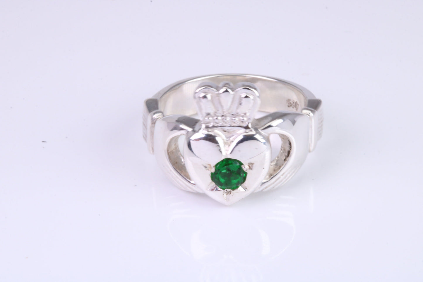 Large and heavy Emerald Green C Z set Claddagh ring, made from solid cast silver, British hallmarked