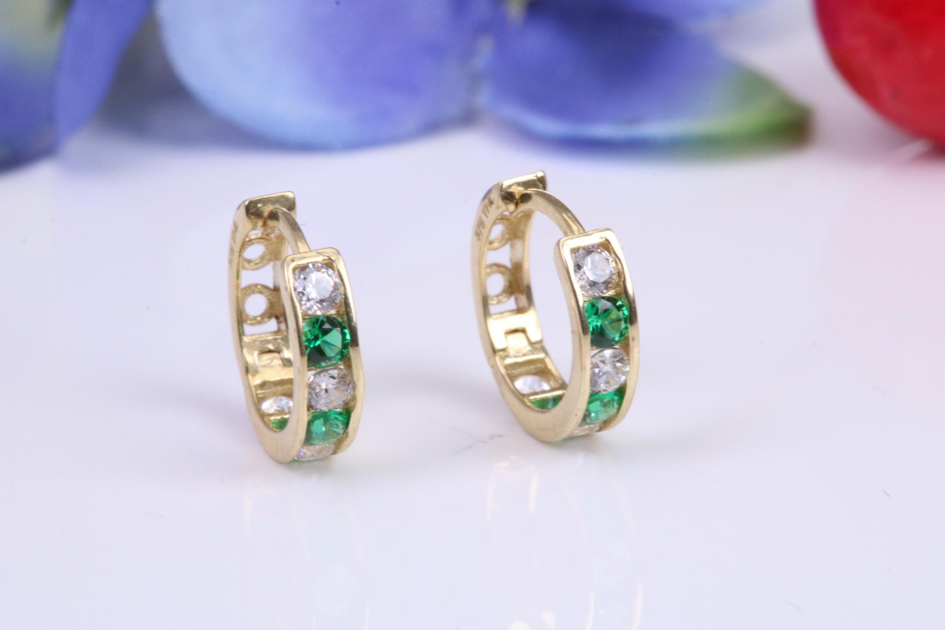 10 mm round hinged hoop earrings, made from solid yellow gold and set with Emerald and Diamond Cubic Zirconia
