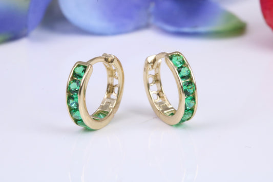 10 mm round hinged hoop earrings, made from solid yellow gold and set with Emerald Green Cubic Zirconia