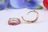 10 mm round hinged hoop earrings, made from solid yellow gold and set with Ruby Red Cubic Zirconia