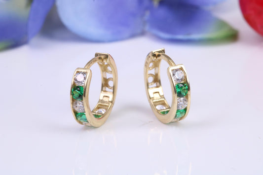 10 mm round hinged hoop earrings, made from solid yellow gold and set with Emerald and Diamond Cubic Zirconia