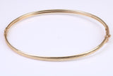 Hinged 3 mm wide yellow gold oval Bangle, British hallmarked