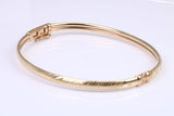 Hinged 4 mm wide yellow gold oval Bangle, British hallmarked