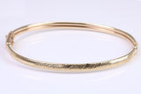 Hinged 4 mm wide yellow gold oval Bangle, British hallmarked
