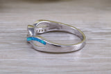 Fiery Blue Opal and cubic zirconia set cross over ring, solid sterling silver ring further rhodium plated for that platinum look
