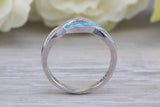 Fiery Blue Opal and cubic zirconia set cross over ring, solid sterling silver ring further rhodium plated for that platinum look