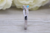Fiery Blue Opal and cubic zirconia set cross over ring, solid sterling silver ring further rhodium plated for that platinum look