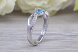 Fiery Blue Opal and cubic zirconia set cross over ring, solid sterling silver ring further rhodium plated for that platinum look