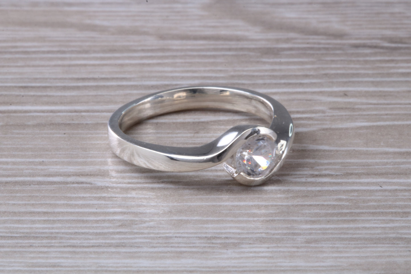 Simple and very elegant real Diamond look ring, sterling silver set with half carat diamond look C Z, very smooth rub over setting
