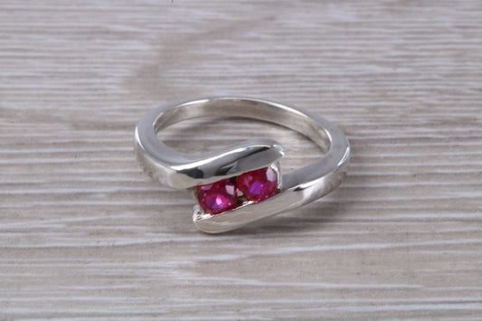 Ruby ring, crossover styled, sterling silver set with two round cut Ruby Cubic Zirconia, Ideal promise, dress engagement ring