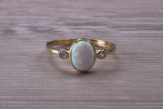 Opal and Diamond White Cubic Zirconia set Trilogy ring, solid 9ct Yellow Gold, very fiery oval cut Cultured Opal