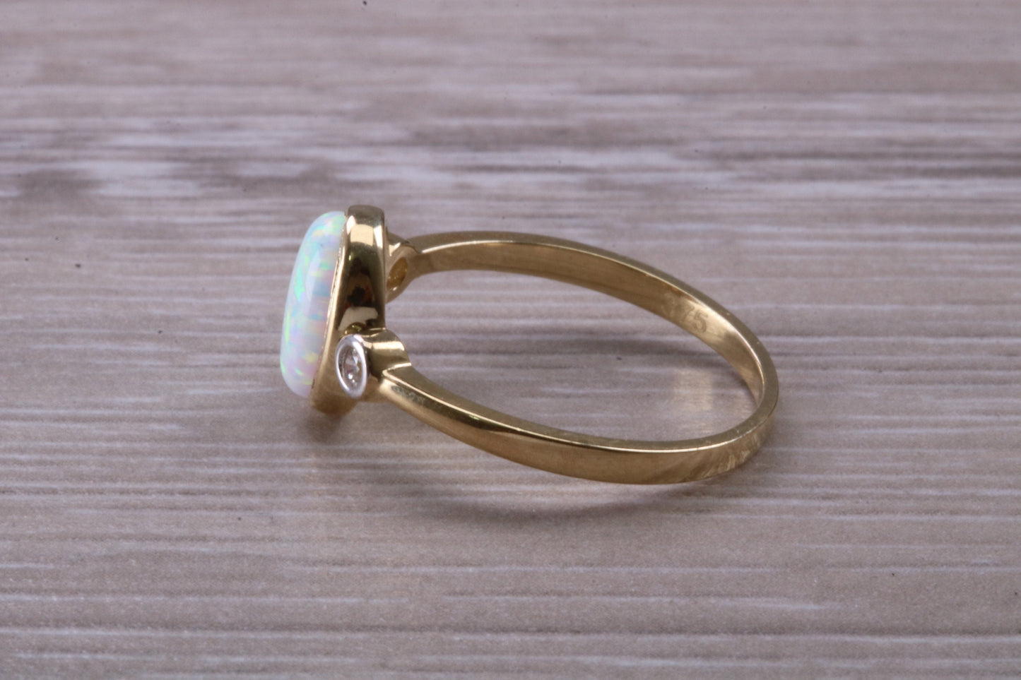 Opal and Diamond White Cubic Zirconia set Trilogy ring, solid 9ct Yellow Gold, very fiery oval cut Cultured Opal