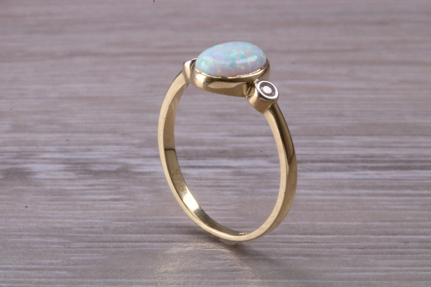 Opal and Diamond White Cubic Zirconia set Trilogy ring, solid 9ct Yellow Gold, very fiery oval cut Cultured Opal