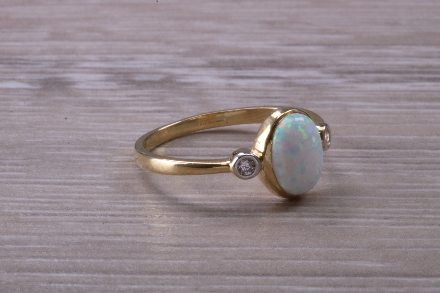 Opal and Diamond White Cubic Zirconia set Trilogy ring, solid 9ct Yellow Gold, very fiery oval cut Cultured Opal
