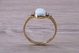 Opal and Diamond White Cubic Zirconia set Trilogy ring, solid 9ct Yellow Gold, very fiery oval cut Cultured Opal