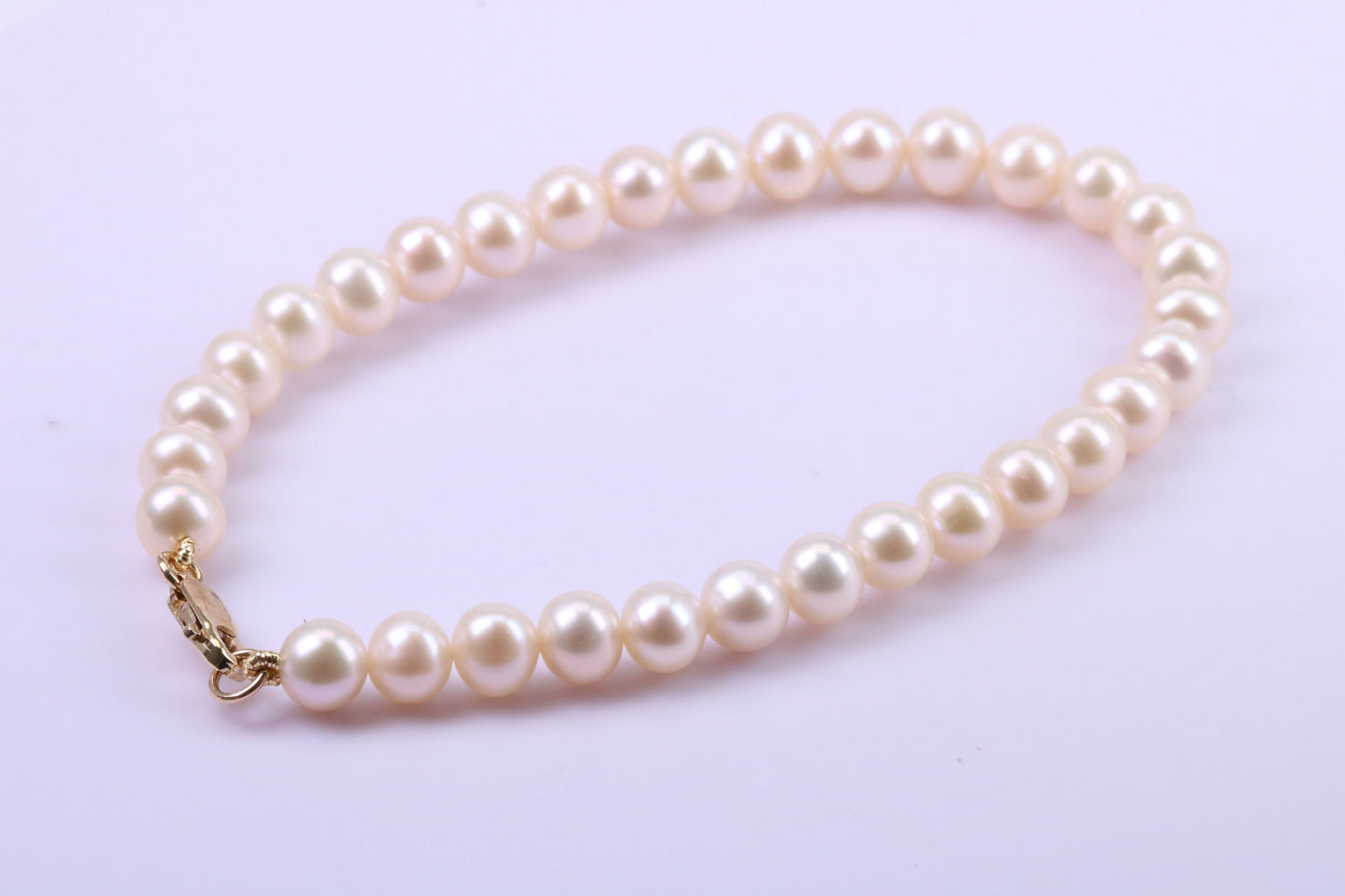 Simple 6 mm Round Natural Freshwater Pearl Bracelet set in Solid Yellow Gold