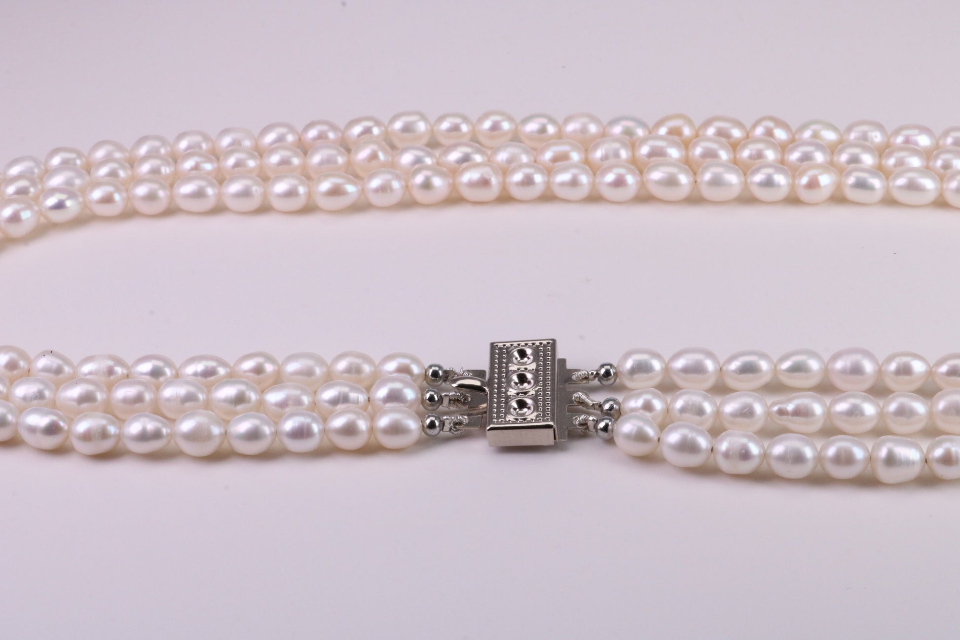 Three Strand Natural 7 mm Oval Shaped Pearl Necklace set in Silver, Three Strands Measures 16, 18 and 20 inches Long