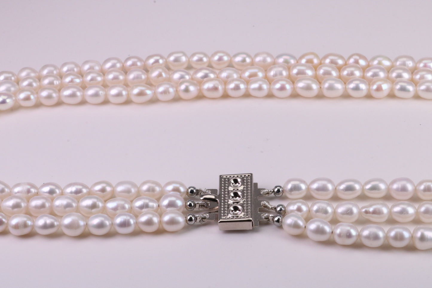 Three Strand Natural 7 mm Oval Shaped Pearl Necklace set in Silver, Three Strands Measures 16, 18 and 20 inches Long