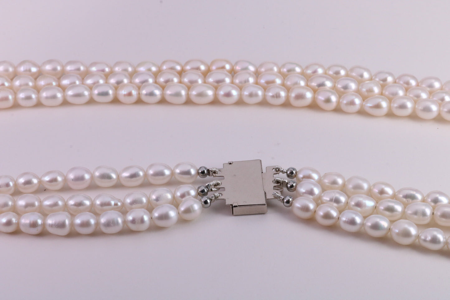 Three Strand Natural 7 mm Oval Shaped Pearl Necklace set in Silver, Three Strands Measures 16, 18 and 20 inches Long